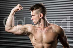 Shirtless man flexing biceps