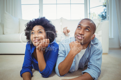 Happy couple lying on the floor