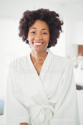 Pretty woman in bath robe smiling at the camera