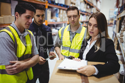 Warehouse manager and workers talking