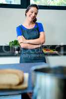 smiling woman standing in front of vegetables