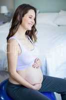 Pregnant woman sitting on exercise ball