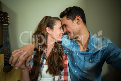 Young couple sitting together on the floor and smiling