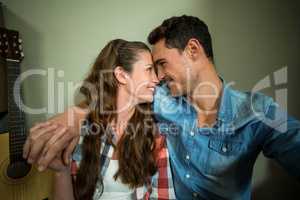 Young couple sitting together on the floor and smiling