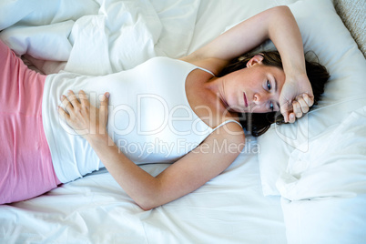 woman lying in bed staring into space