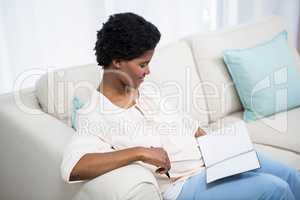Pregnant woman holding notebook