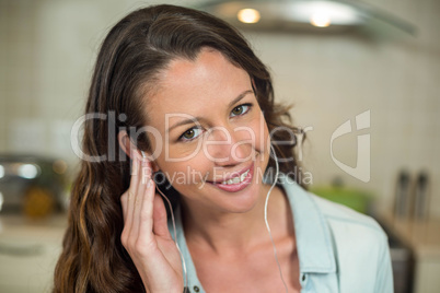 Portrait of young woman listening to music