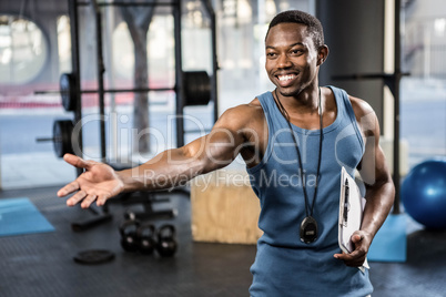 Confident trainer showing the gym to the camera