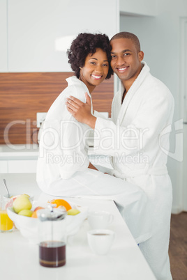 Happy couple hugging in the kitchen