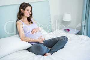 Pregnant woman touching her belly