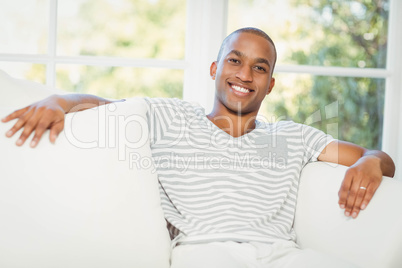 Handsome man sitting on the sofa