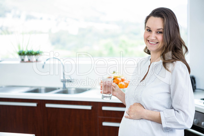 Pregnant woman holding a glass of water