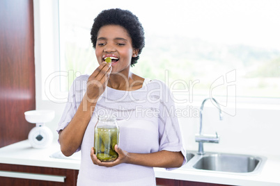 Pregnant woman eating pickles