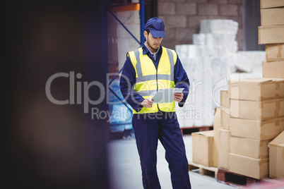 Portrait of warehouse worker with clipboard