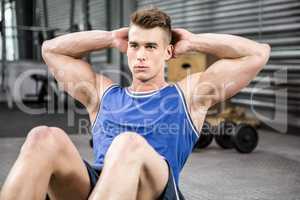 Muscular man doing abdominal crunches