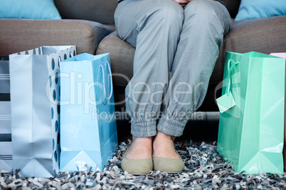 Womans feet surrounded by gift bags