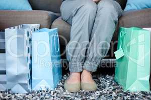 Womans feet surrounded by gift bags