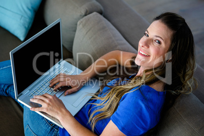 smiling business woman typing on her laptop