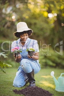 Smiling woman crouching in the garden