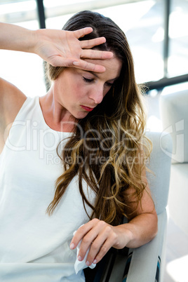 sick woman with her hand to her head