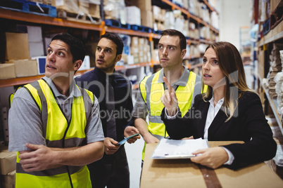 Warehouse manager and workers talking