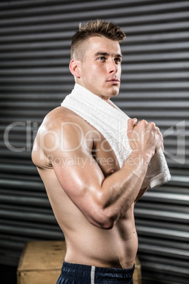 Shirtless man with towel around neck