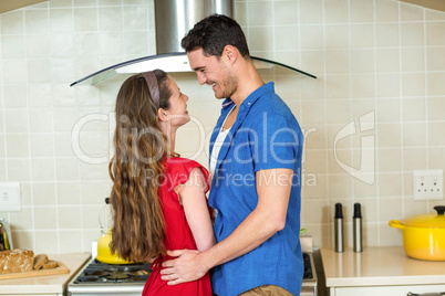 Romantic couple standing face to face and embracing each other