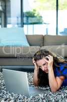stressed woman looking at her laptop