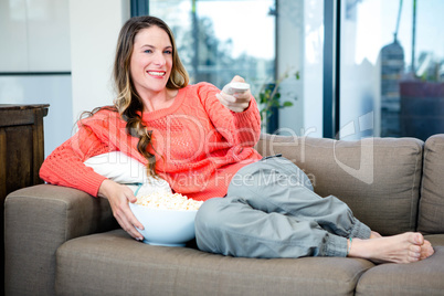 woman lying on the couch with popcorn