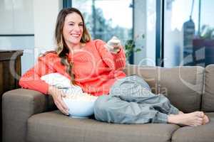 woman lying on the couch with popcorn
