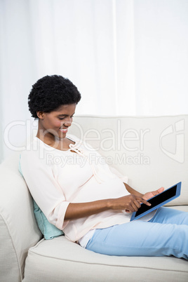 Pregnant woman using tablet