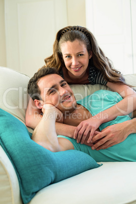 Young couple embracing on sofa