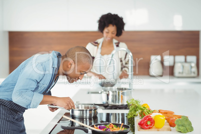 Happy couple preparing meal