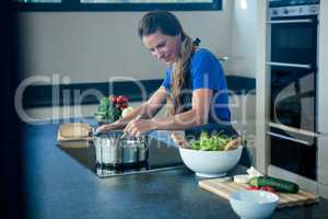 smiling woman cooking on the stove top