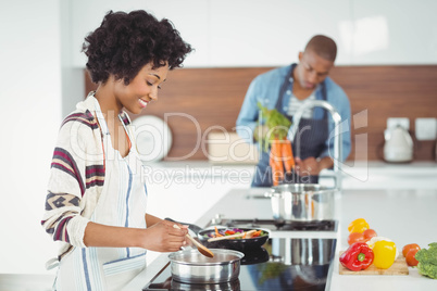 Happy couple preparing meal