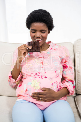 Pregnant woman eating chocolate