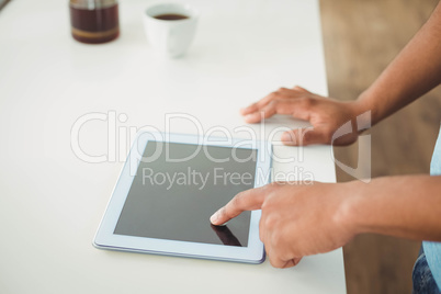 Close up of mans hands using tablet