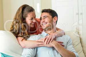 Young couple embracing on sofa