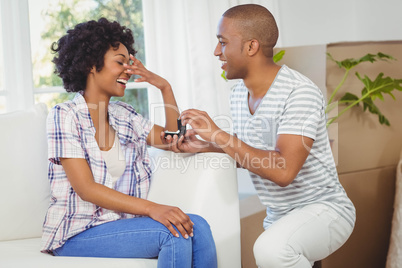 handsome man offering engagement ring to his girlfriend