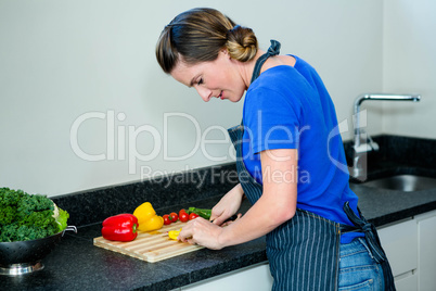 smiling woman preparing vegetables for dinner