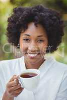 Smiling woman holding tea