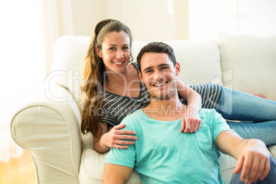 Portrait of happy young couple enjoying together in living room