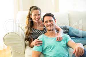 Portrait of happy young couple enjoying together in living room