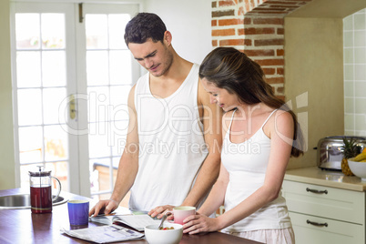 young couple looking their personal organizer in morning