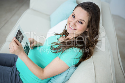 Pregnant woman looking at ultrasound scans