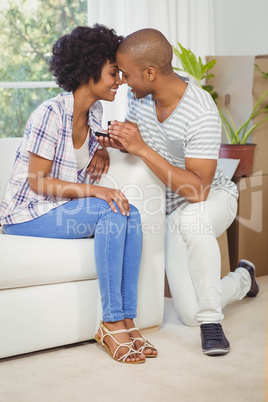 handsome man offering engagement ring to his girlfriend