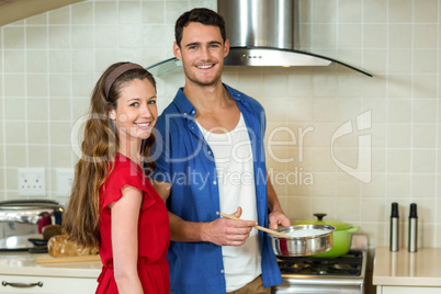 Young couple working together in kitchen
