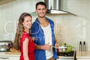 Young couple working together in kitchen