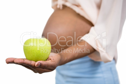 Pregnant woman holding apple