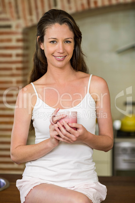 Portrait of young woman holding a cup of tea